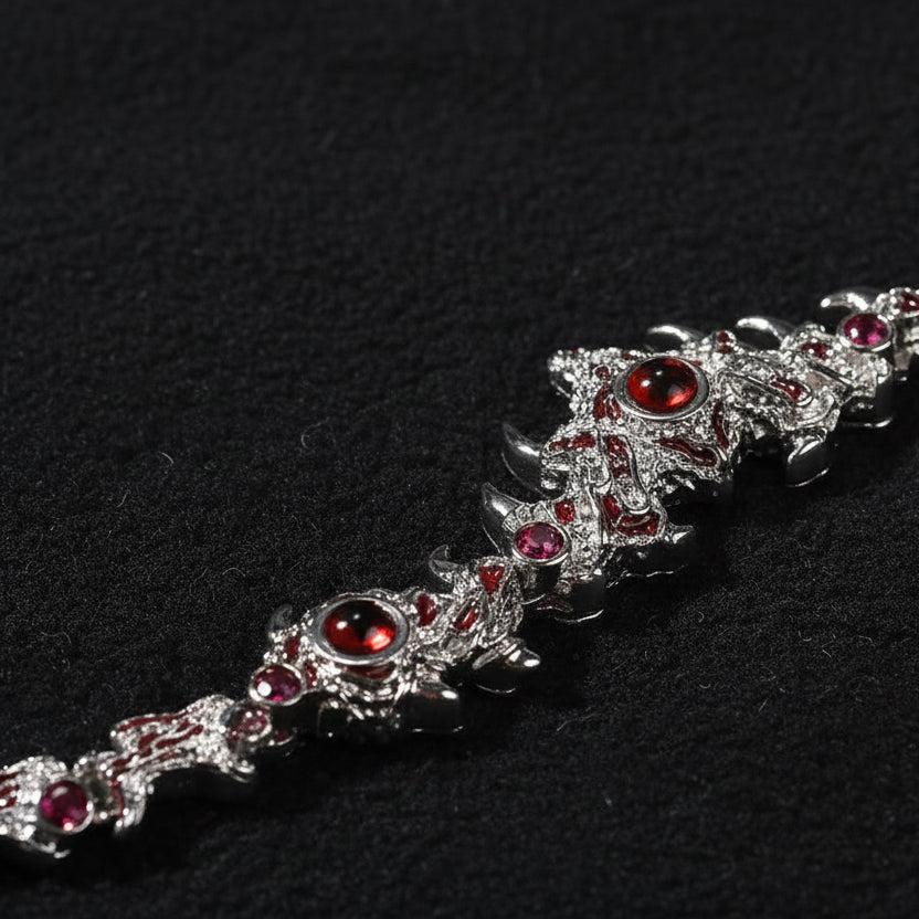 Close-up of a silver-tone statement chain necklace with red gemstones
