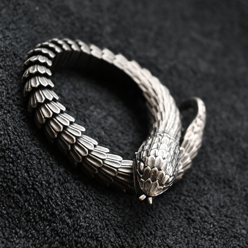 Silver-tone snake bracelet with scale texture and a snake-head clasp